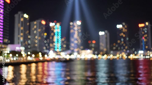 Out of focus city skyline lights reflecting on water