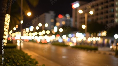 Blurred urban street at night with glowing bokeh lights