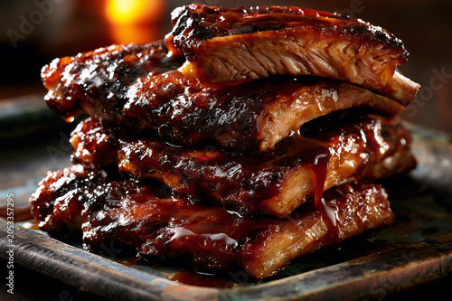 Slow cooked brown sugar glazed pork ribs stack on a rustic platter
