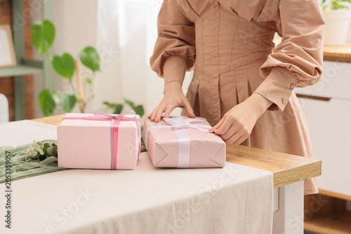 Woman's hands wrapping pink...