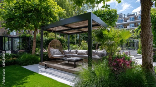 Outdoor lounge space with a seating area surrounded by greenery in a garden during a sunny day