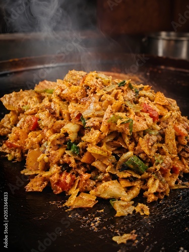 Spicy Street Style Kothu Parotta Food on Iron Griddle