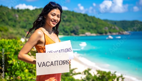 Woman holding vacation sign by ocean.