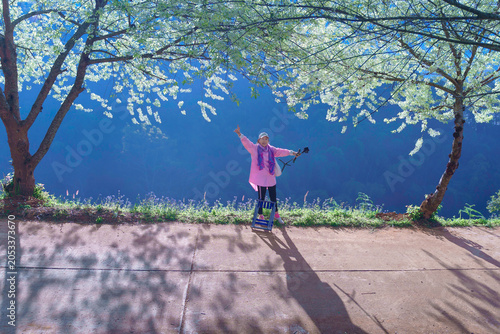 Asian woman traveller with nature flowers, are wild Himalayan cherry or Thai Sakura at Royal Agricultural Station Angkhang in Chiang Mai.