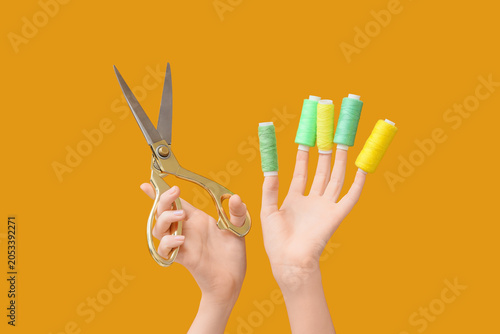 Hands holding golden scisso...