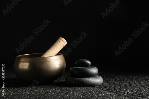 Canvas Print Tibetan singing bowl and stacked zen stones for meditation, relaxation, and spir