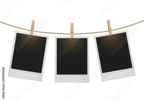 Three blank polaroid photos hanging on a rope with clothespins outdoor transparent background
