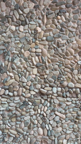Konstfotografi A detailed pebble stone wall featuring natural gravel textures and decorative stone patterns
