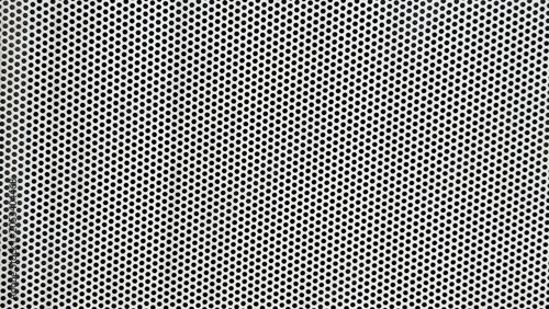 Tableau sur toile A close-up view of a perforated steel plate featuring evenly spaced small holes across a durable metal surface