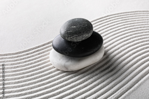 Photography Zen garden stone cairn with stacked pebbles on raked sand, balance and harmony i