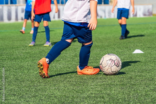 Billede på lærred faceless image of a group of children training or playing a grass soccer game