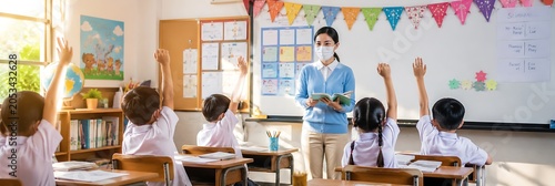 Masked Teacher in Classroom: A teacher wearing a protective face mask instructs a class of young students in a bright, sunlit classroom, where eager pupils raise their hands to answer questions.