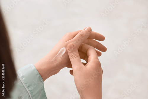 Woman applying hand cream f...
