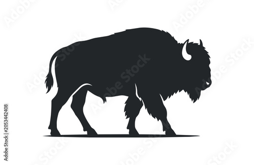Silhouette of a majestic bison walking with determination.