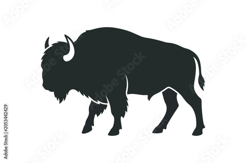 Silhouette of a majestic American Bison walking forward.