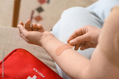Person applying adhesive ba...