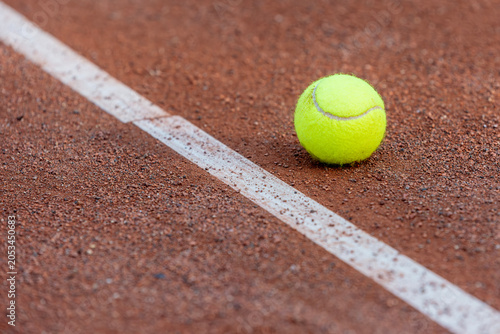 Tennis Ball on Clay Court During Tournament Season