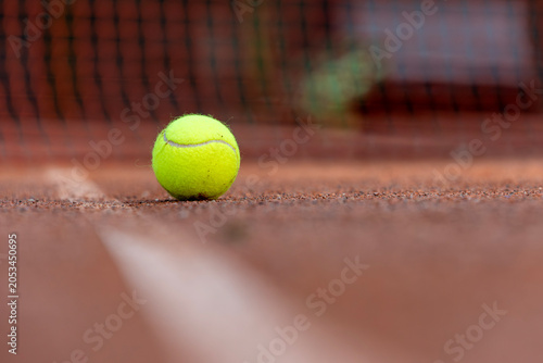 Tennis Ball on Clay Court During Tournament Season