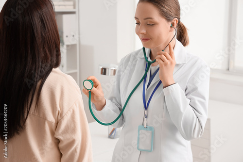 Female doctor listening to ...