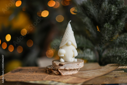 Unique handmade soy wax candles, cozy room with wooden decorations and Christmas lights in the background