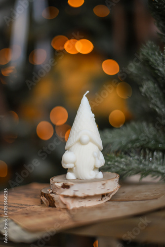 Unique handmade soy wax candles, cozy room with wooden decorations and Christmas lights in the background