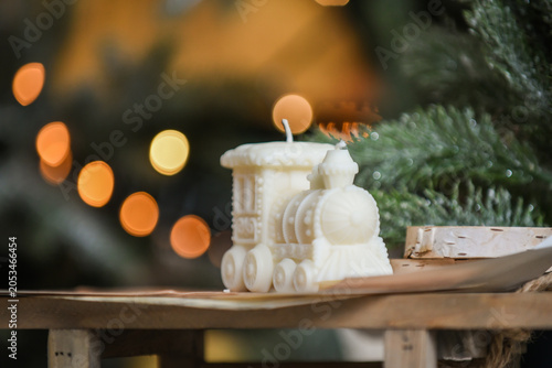 Unique handmade soy wax candles, cozy room with wooden decorations and Christmas lights in the background