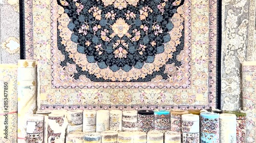 Multiple Persian carpets for sale at the store. Traditional hand-woven rugs with Vibrant colors.