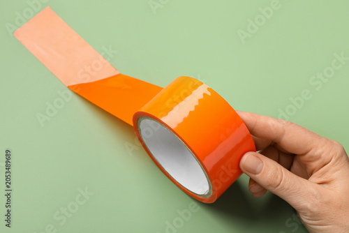 Hand holding bright orange ...