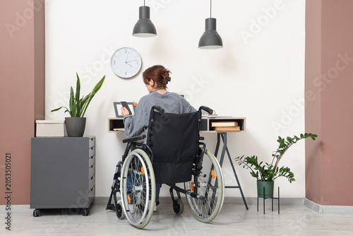 Woman in wheelchair working...