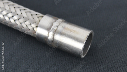 Bild auf Leinwand Stainless Braided Hose Welded Fitting on Dark Background