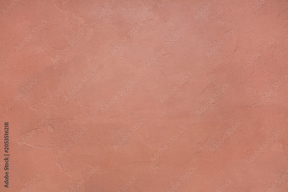 Fototapeta premium Textured peach wall background with rough plaster surface, abstract design element for interior decor and graphic projects