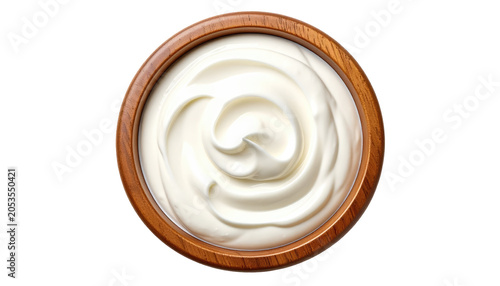 Overhead shot of a smooth, white, creamy substance filling a round, wooden bowl. Swirls and textures are visible