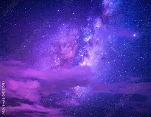 A stunning celestial panorama; vibrant hues of purple, blue, and pink illuminate the night sky