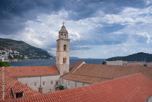 Dubrovnik Old Town with red terracotta roofs, the historic bell tower of the Dominican monastery and the harbor on the blue Adriatic Sea, in Croatia