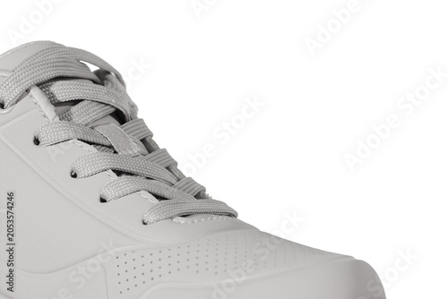 White athletic sneaker with textured upper and laced closure .