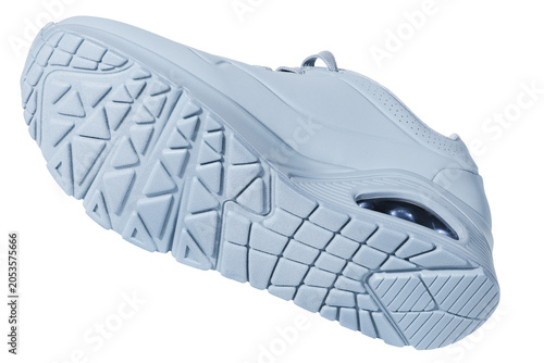 Isolated white sports sneaker levitating against a seamless white background. The image highlights the textured rubber outsole with triangular and grid tread