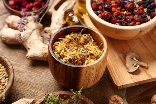 Bowls with dried herbs, ber...
