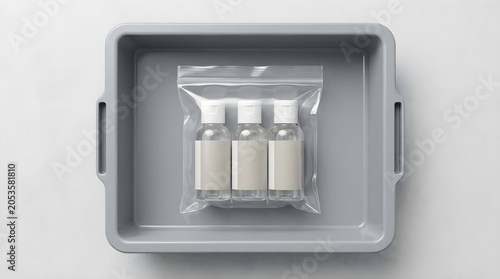 Travel size toiletries bottles in clear plastic zip lock bag on airport security screening tray