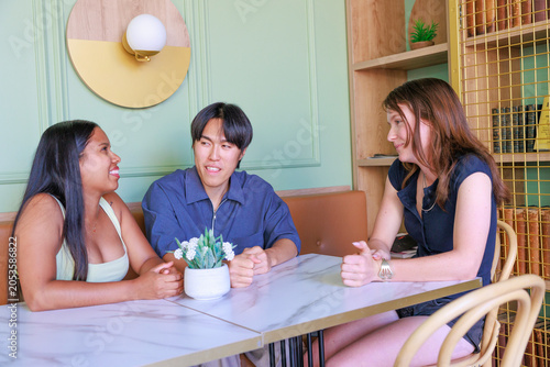 International Friends Having Conversation in Modern Cafe