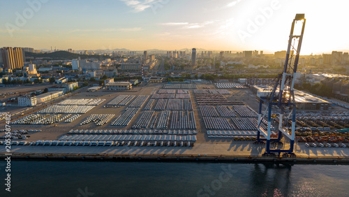 Port Container Yard and Urban Skyline at Sunrise