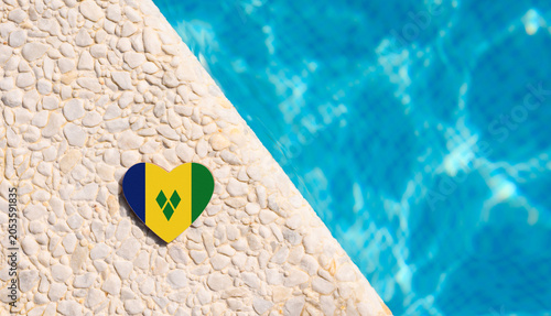 Schilderij op canvas Saint Vincent and the Grenadines flag in the shape of a heart near the pool in the hotel