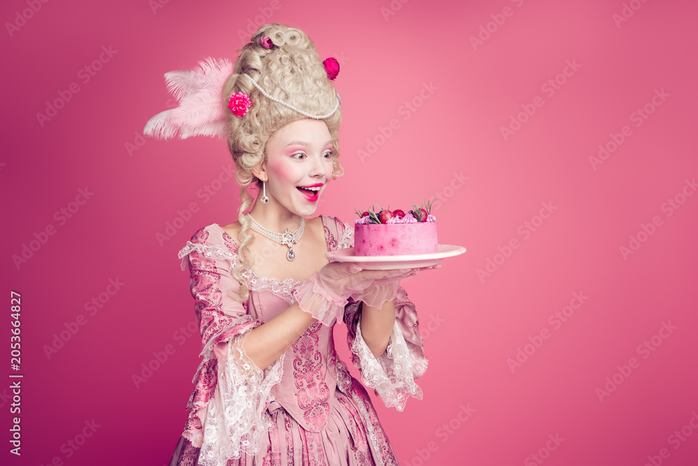 Fototapeta premium Photo of charming impressed marie antoinette wear rich dress eating birthday cake empty space isolated pink color background