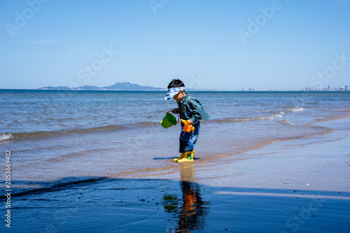Young Child Playing With Toys At Sunny Seashore