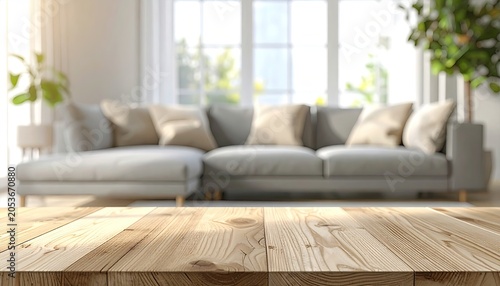 Soft-focus modern living room with gray sofa; wood table foreground