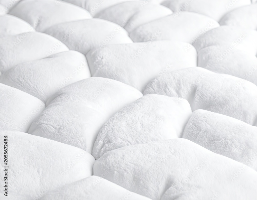 Fototapeta premium Close-up textured white fluffy surface with repeating quilted pattern