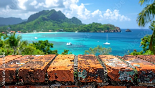 Rough brick wall frames a clear turquoise bay, boats, and green mountains