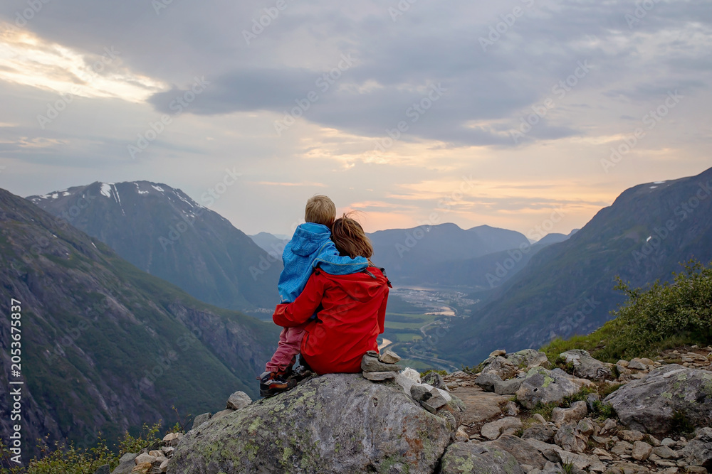 Fototapeta premium Family with children and dog, hiking in Litlefjellet on sunset, enjoying amazing view from the top of hiking trail