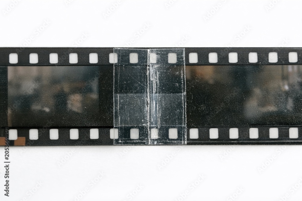 Fototapeta premium A close-up shot of a film strip lying on a white surface, perfect for photography or film-related uses