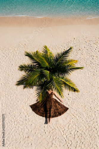 Top down view of a creative sand art concept of a human palm tree