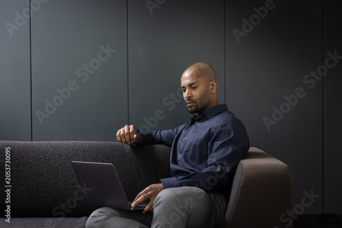 Businessman Working on Laptop in a modern office